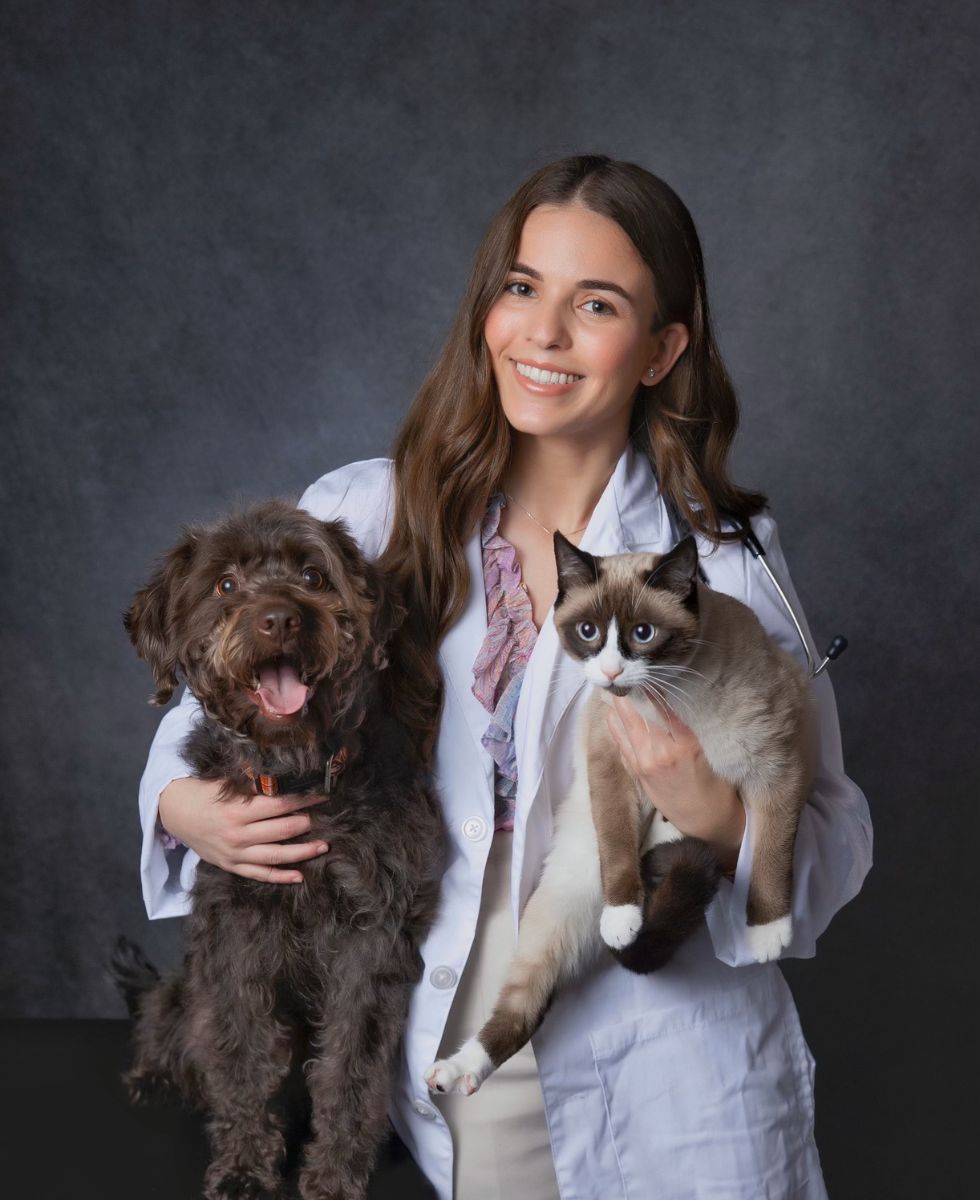 Stephanie Acosta holding dog and cat