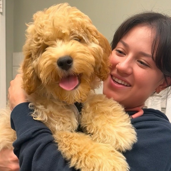 Happy woman holding a fluffy puppy